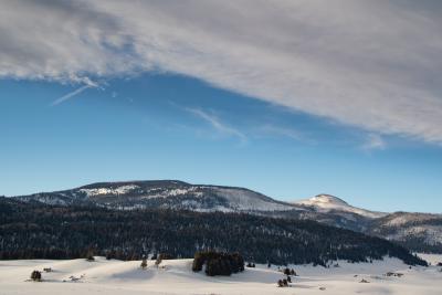 View of the snow-covered Valles Caldera National Preserve and mountains in the distance